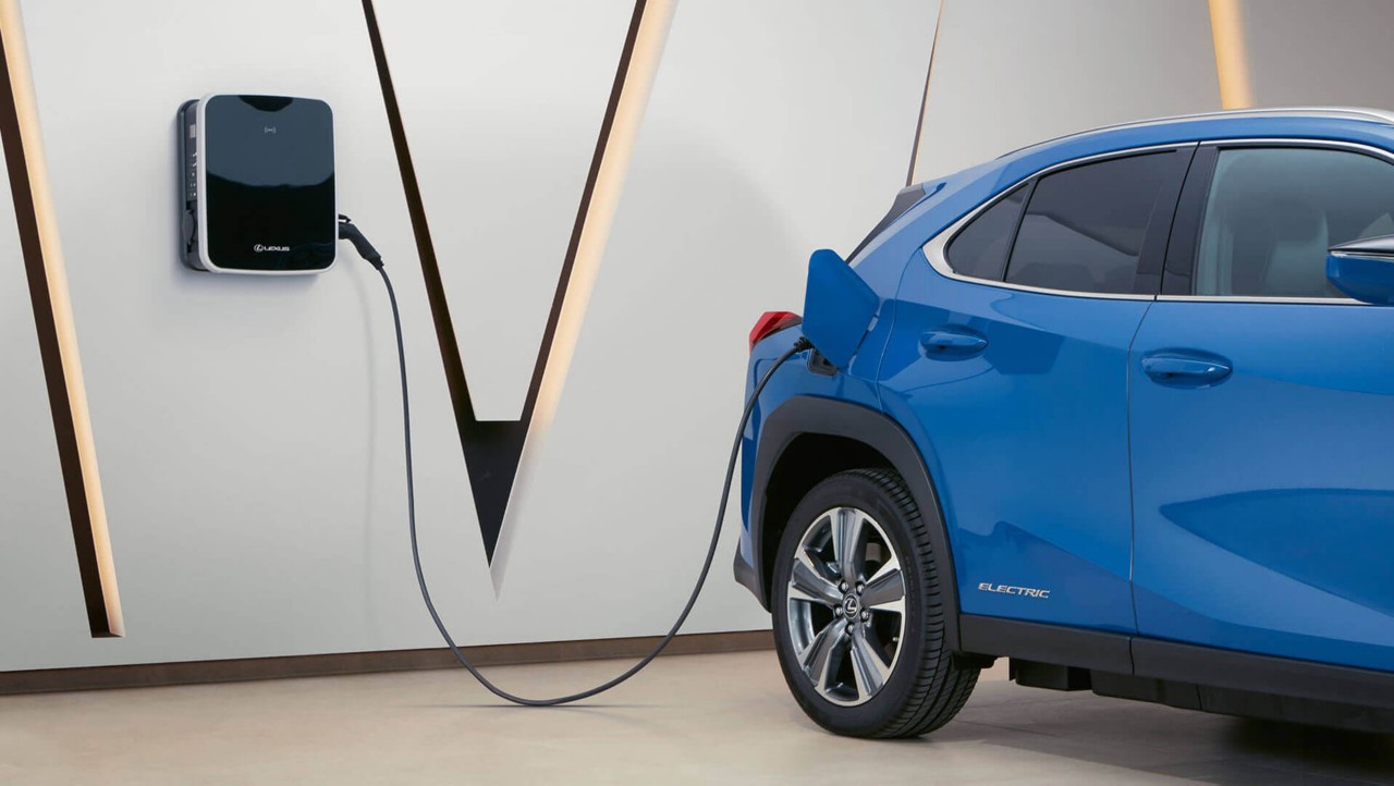 A Lexus UX 300e plugged into a charging port
