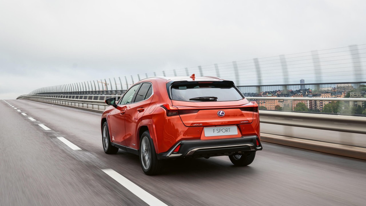 Rear view of Lexus UX driving on a road