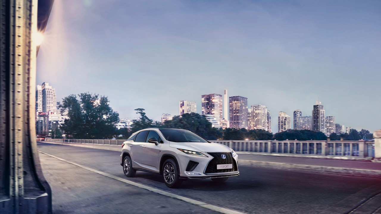 Lexus RX F Sport driving in a city location 