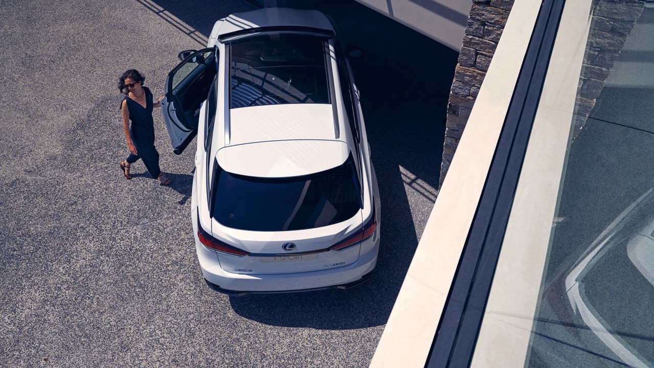 A woman entering a Lexus RX F Sport 